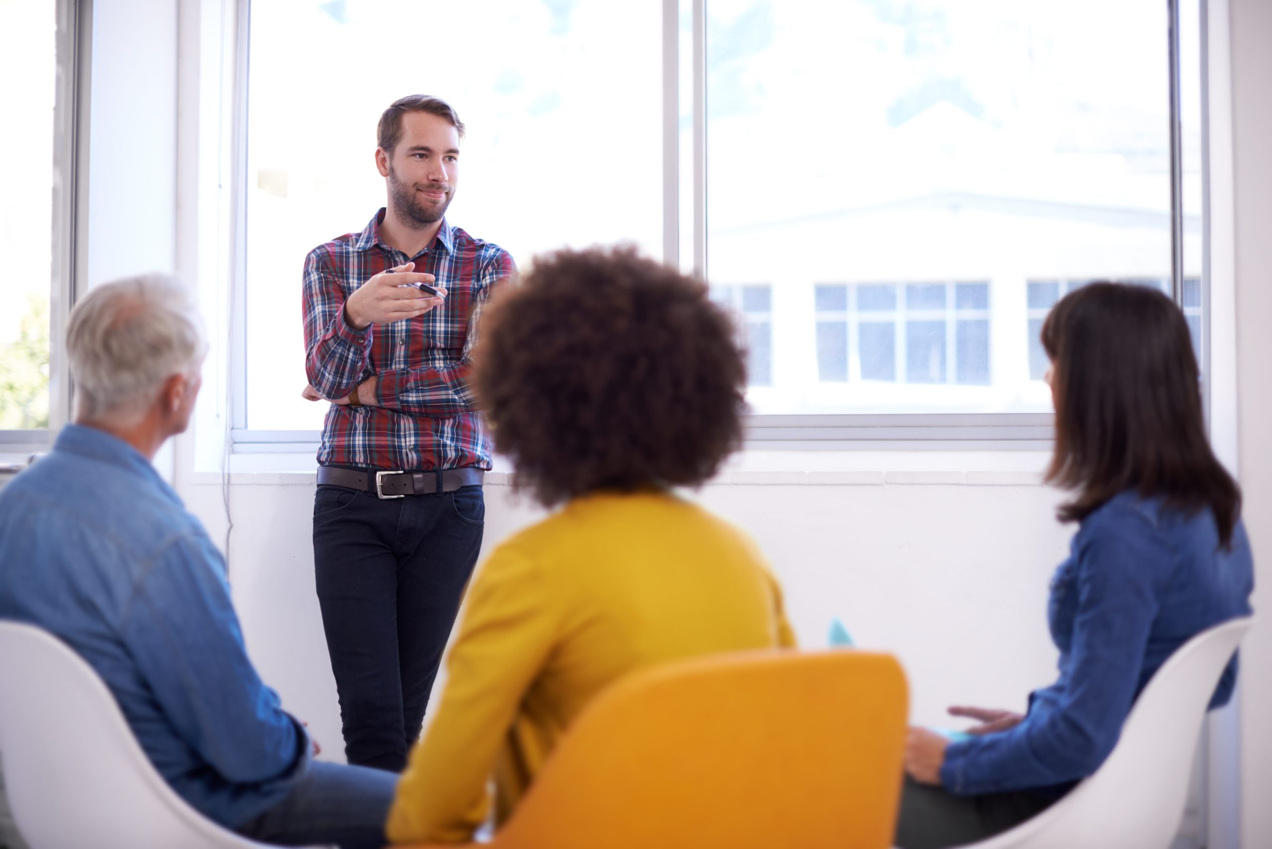 Explanation is an artform. Shot of a group of coworkers in a meeting.